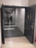 fire-rated double-leaf steel door with a flat rebate are equipped with EI30 glazings in a form of a porthole, electromagnetic door holders, a latch of a passive door leaf, overhead door-closers, and closing sequence regulator